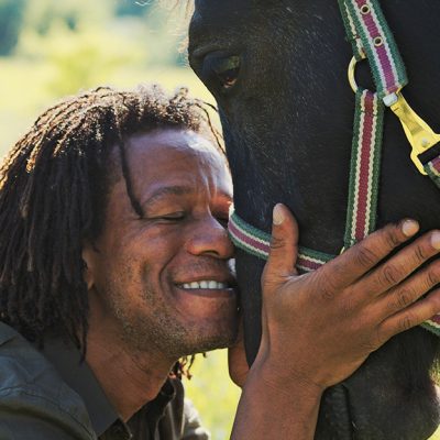 African American man and horse making a spiritual connection.